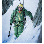 Ein Bergsteiger in voller Montur in Fels und Eis am Steilhang